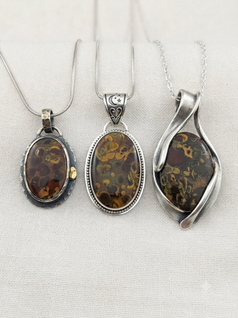 Amber-Brown Jasper Pendants, Patterned brown and golden jasper; oval and wrapped settings